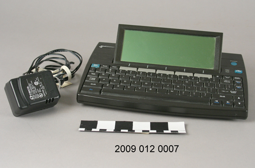 A small electronic piece that consists of a pop-up screen attached to a keyboard.